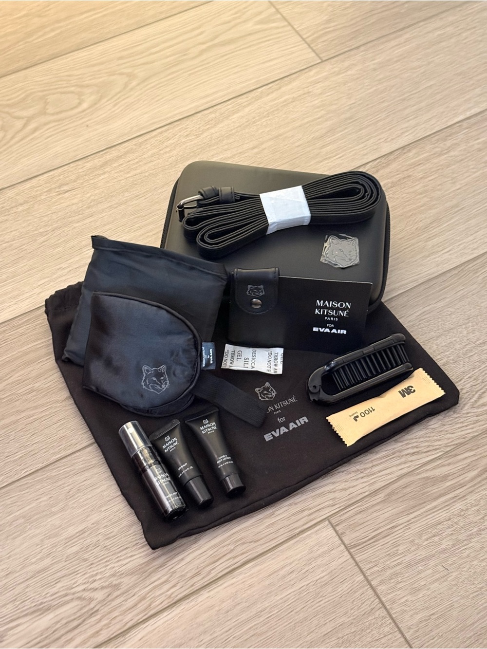 MAISON KITSUNÉ x EVA Air Royal Laurel Class business class amenity kit in black.